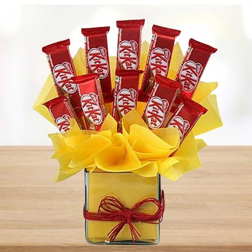Remarkable Arrangement of Kitkat Chocolates in Glass Vase Remarkable Arrangement of Kitkat Chocolates in Glass Vase