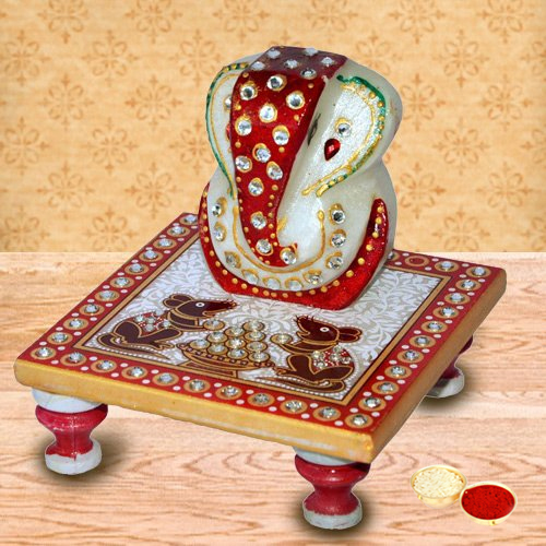 Delicately carved marbel designer ganesh with chowki with free Roli Tilak and Chawal Delicately carved marbel designer ganesh with chowki with free Roli Tilak and Chawal