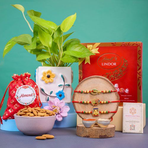 Sacred Rakhi Trio with Chocolates and Greens Sacred Rakhi Trio with Chocolates and Greens
