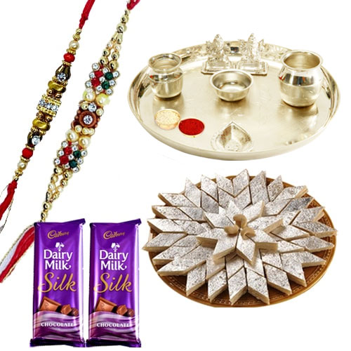 An Exclusive Gift Hamper with Silver Plated Thali Delicious Kaju Katli and Gift E Voucher from Raymond along with 2 free Rakhi,Roli Tika and Chawal An Exclusive Gift Hamper with Silver Plated Thali Delicious Kaju Katli and Gift E Voucher from Raymond along with 2 free Rakhi,Roli Tika and Chawal