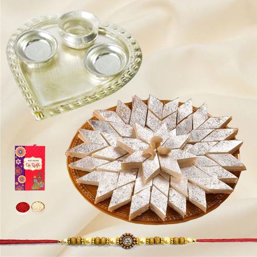 Irresistible Kaju Katli from Haldiram and Fancy Silver Plated Paan Shaped Puja Aarti Thali with Rakhi Roli Tilak and Chawal for your Loving Brother