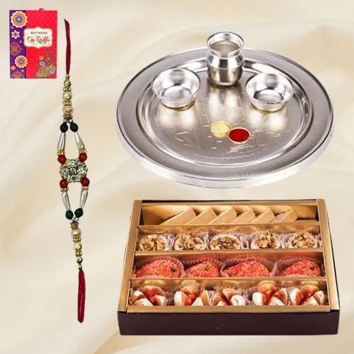 Assorted Sweets from Haldiram and Silver Plated Paan Shaped Puja Aarti Thali along with Rakhi Assorted Sweets from Haldiram and Silver Plated Paan Shaped Puja Aarti Thali along with Rakhi
